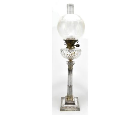 A late 19th century silver plated oil lamp, the frosted glass shade with floral detail above cut glass reservoir with silver 