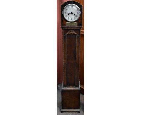 An early 20th century oak cased eight day longcase clock of small dimensions, the circular dial set with Arabic numerals, abo