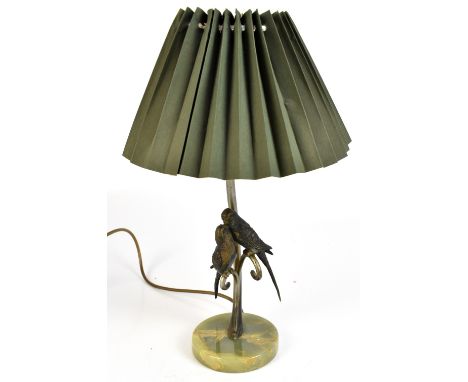 A table lamp featuring a pair of bronzed metal budgerigars on silvered column to circular onyx base, height including fitment