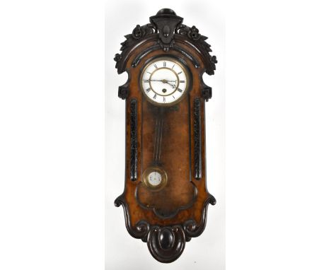 A Victorian walnut cased thirty hour wall clock with carved foliate and scroll detail, the circular enamel dial set with Roma