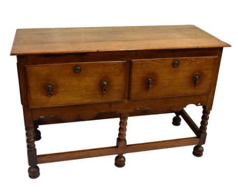 A 19th century oak dresser, the rectangular top above two deep frieze drawers and shaped apron on bobbin turned stretchered s