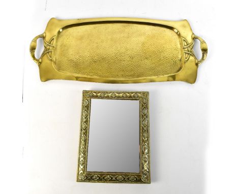 An Art Nouveau brass twin handled tray, the handles cast with floral detail flanking a central planished body, length 65cm, a