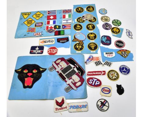 A collection of vintage cloth badges with automobile interest including Esso, Daytona International Speedway, Mercedes-Benz, 