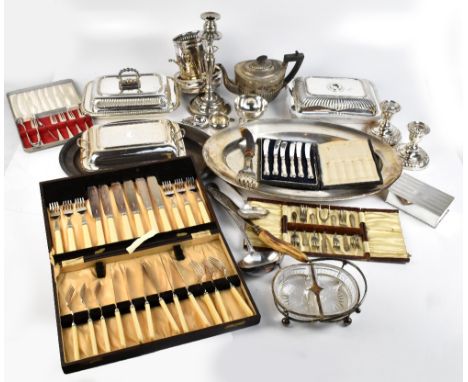 A mixed group of electroplated items including lidded tureens, bottle coasters, pair of squat candlesticks, antler handled fi