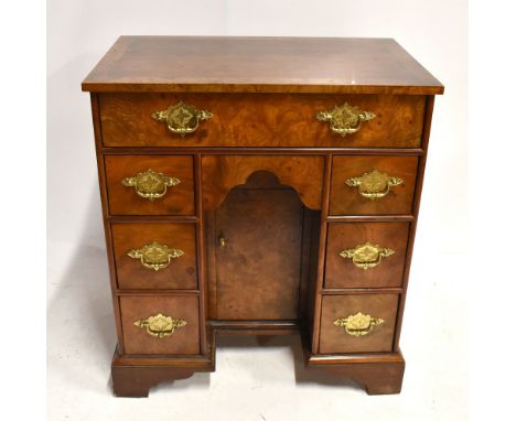 A George III style mahogany seven drawer kneehole desk on bracket feet, height 71.5cm, width 63.5cm, depth 40.5cm.Additional 