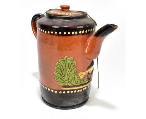 A 19th century folk art treacle glazed lidded jug decorated with a stylised bird amongst foliage, height 23.5cm, unmarked.Add