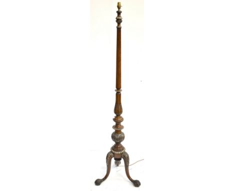 A good mahogany standard lamp carved in the Irish style with turned fluted column and carved tripod supports with hairy paw f