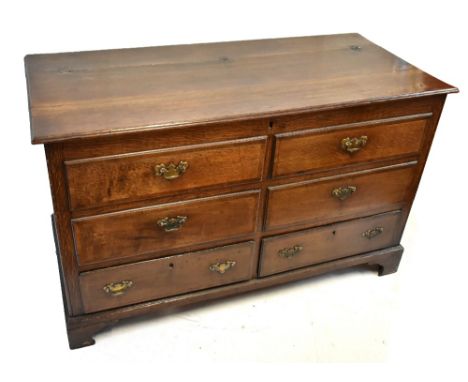 A 19th century oak blanket chest, the hinged lid above four dummy drawers and two base drawers on bracket feet, width 135cm, 