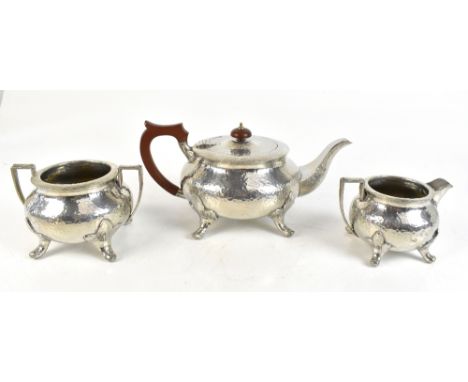 ENGLISH PEWTER; an Arts &amp; Crafts pewter three piece tea service, with planished decoration, impressed no.259 to base.Addi