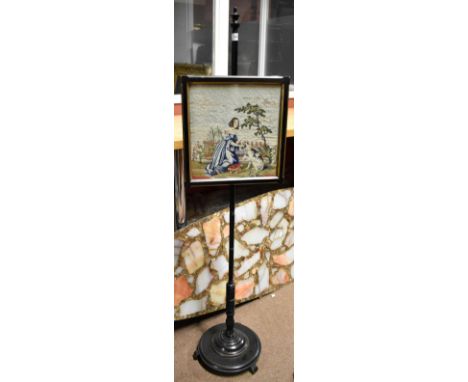 A late Victorian ebonised pole screen with tapestry panel depicting a child and a dog, height 135cm.Additional InformationNum