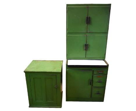 A vintage green painted kitchenette cabinet, a green painted pine cupboard with panelled door, also vintage scales and cake t