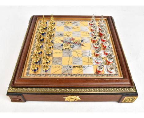 THE FRANKLIN MINT; a Waterloo chess set and board, height of king/Napoleon 5.6cm.Additional InformationOne of the corner plat