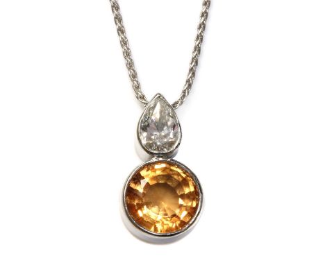 An 18ct white gold topaz and diamond pendant,with a circular mixed cut topaz, rub set in a plain collet, below a pear cut dia