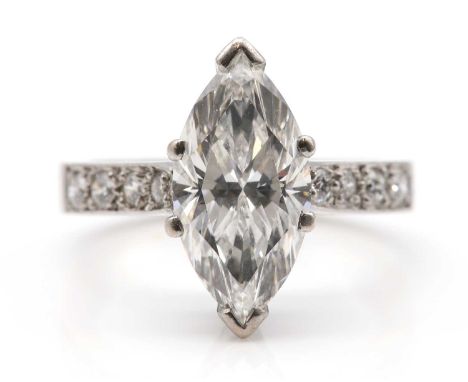 An 18ct white gold single stone marquise cut diamond ring,with diamond set shoulders. The marquise cut diamond with a known w