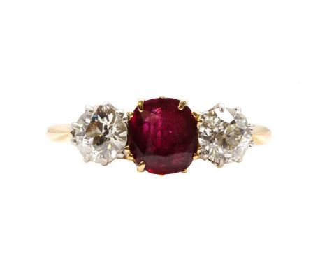 A gold ruby and diamond three stone ring, a cushion cut ruby with an old European cut diamond at each side, all claw set to r