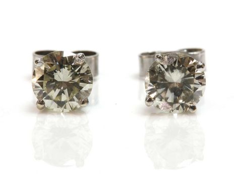 A pair of single stone diamond earrings,with a brilliant cut diamond, four claw set in a wire collet with post and butterfly 