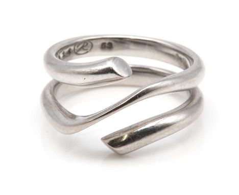 An 18ct white gold 'Magic' ring, by Georg Jensen,of coiled court section form, with a knife edge centre, no.1314. Common conv