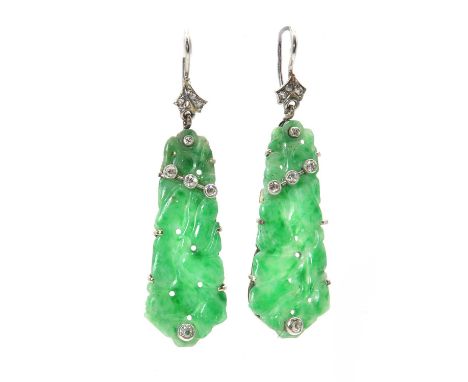 A pair of Art Deco jade and diamond drop earrings, a tapered, carved, pierced jade plaque, claw set to a white gold frame, wi