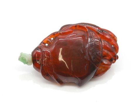 A Chinese amber and nephrite jade snuff bottle, Qing Dynasty (1644-1911),carved with a peach and leaf and finger citron, with