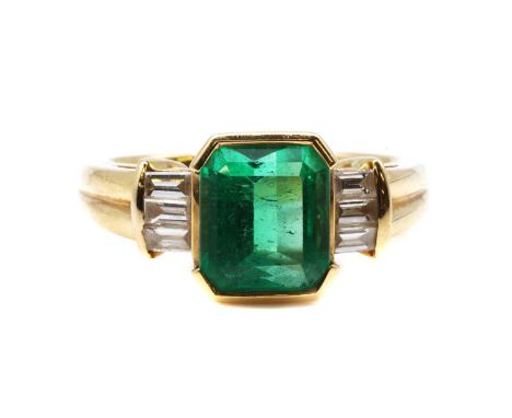 A single stone emerald ring with diamond set shoulders, by Colombian Emeralds International, c.2005,with an emerald cut emera