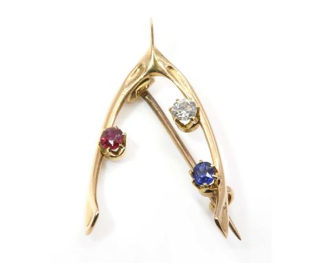 A late Victorian sapphire, diamond and ruby wishbone brooch,with an old European cut diamond and an oval Swiss cut ruby and s