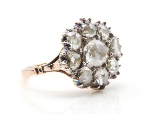 A Georgian rose cut diamond cluster ring,with an oval foil backed Dutch rose cut diamond to the centre. A border of smaller c