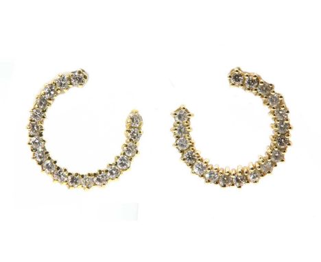 A pair of diamond set hoop style earrings,with a row of brilliant cut diamonds, claw set to an open hoop with post and butter