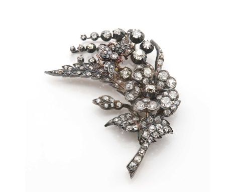 A Victorian diamond set en tremblant spray and bee brooch, c.1880,with a rose bloom and spray of Lily of the Valley and ferns