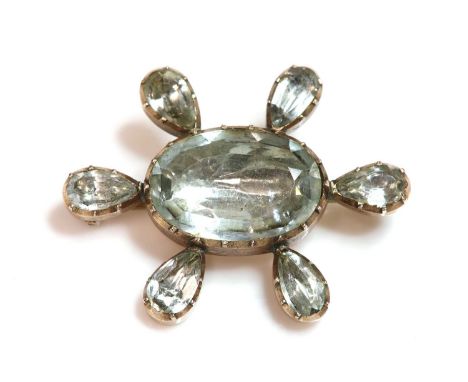 A Georgian foiled aquamarine brooch,with an oval Lisbon cut foiled aquamarine, set in a cut down collet to the centre. A spac