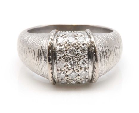 A diamond set bombé ring, by Piaget,with a central band of pavé set brilliant cut diamonds. Raised twisted wire guards to eac