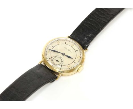 A gentlemen's 9ct gold Jaeger-LeCoultre mechanical strap watch,with a 30.45mm case. A silvered dial with gilt and black Roman