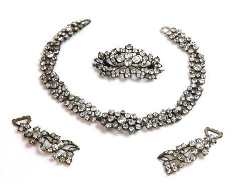 A French late 18th century paste necklace,with a series of paste set cluster plaque links. Graduated modified rose/step cut f