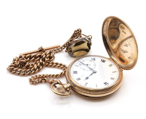 A 9ct gold side wind hunter pocket watch, 49mm diameter with plain polished covers. A white enamel dial with black Roman nume