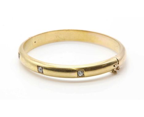 An Edwardian diamond set hollow hinged bangle,of 'D' section form, 7.40mm wide. Three old European cut diamonds, each one gra