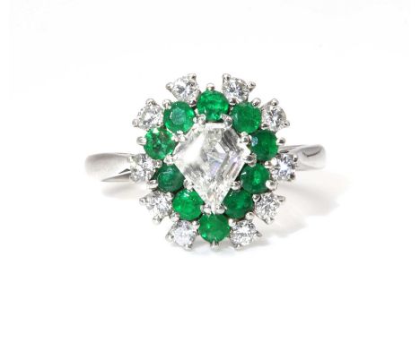 A diamond and emerald pear shaped cluster ring,with a kite cut diamond, with an estimated weight of approximately 0.70ct, cla