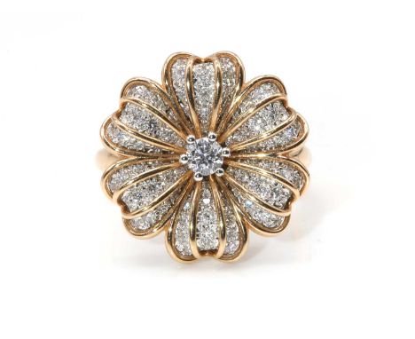 A two colour rose and white gold diamond set flower head ring,with a brilliant cut diamond, claw set in white to the centre. 