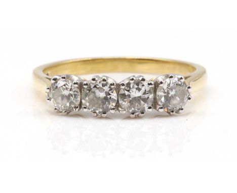 An 18ct gold four stone diamond ring,with four brilliant cut diamonds, claw set in white rex collets, to yellow underbezels, 