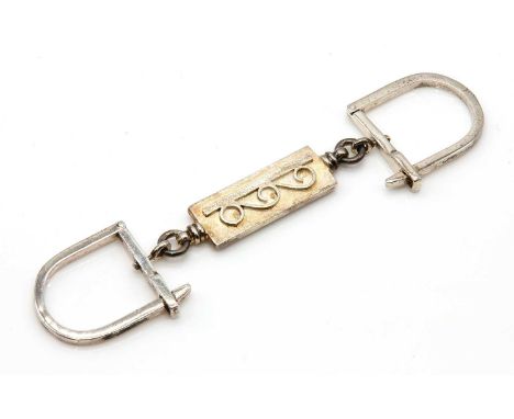 A Greek silver double sided keyring, by Zolotas,with a central rectangular plaque, with raised Vitruvian scroll decoration, w