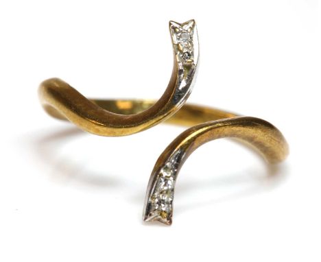 A diamond set crossover torque ring, by Graff,with pairs of eight cut diamonds, grain set in white to a yellow bale. Marked 1