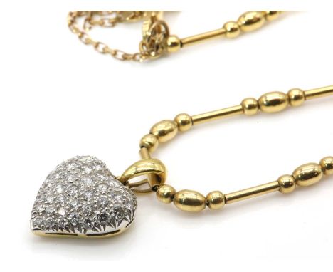 An 18ct yellow and white gold diamond set heart shaped necklace, by David Morris, c.1995,the bombé form white gold heart, pav