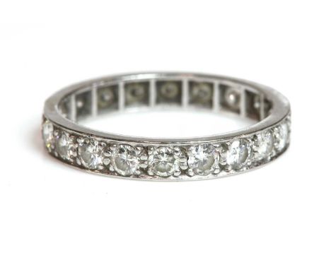 A diamond set full eternity ring,with a row of brilliant cut diamonds, grain set to a flat section band, with plain polished 