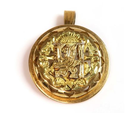 A pre-Columbian style gold pendant/brooch,with a bird man holding a staff applied to an incised ground. A circular pierced bo