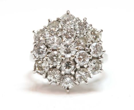 A three tier diamond hexagonal cluster ring,with brilliant cut diamonds, claw set to a stepped hexagonal head. A straight wir