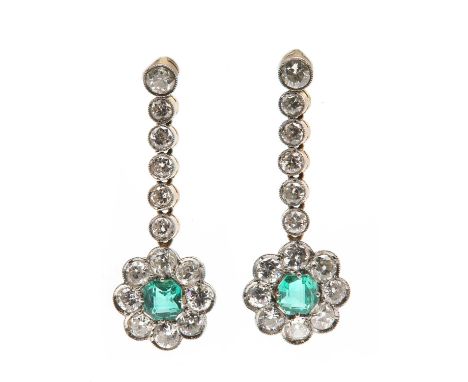 A pair of emerald and diamond drop earrings, c.1930,with an emerald and diamond daisy cluster terminal. An octagonal step cut