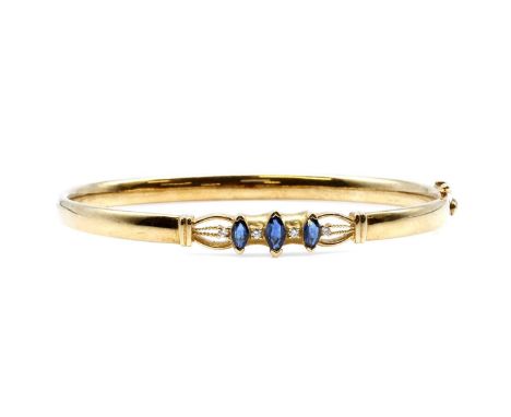 A sapphire and diamond hinged bangle, by Colombian Emeralds International,with marquise cut sapphires, all chevron claw set i