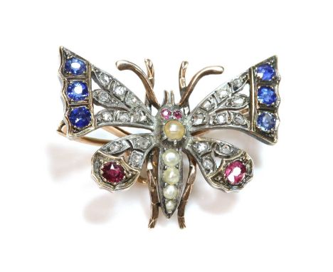 A split pearl, sapphire, ruby and diamond, butterfly brooch, c.1900,with graduated split pearls, forming the abdomen and thor