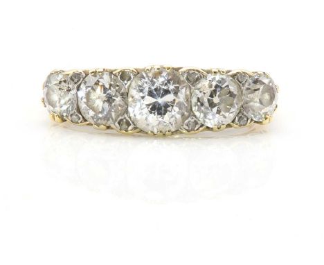 A late Victorian graduated five stone diamond carved head ring,with five graduated old European cut diamonds, claw set to a c