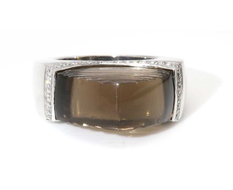 A white gold smoky quartz and diamond ring, attributed to Amanda Wakeley, c.2007,with a flat section trilliant shaped smoky q