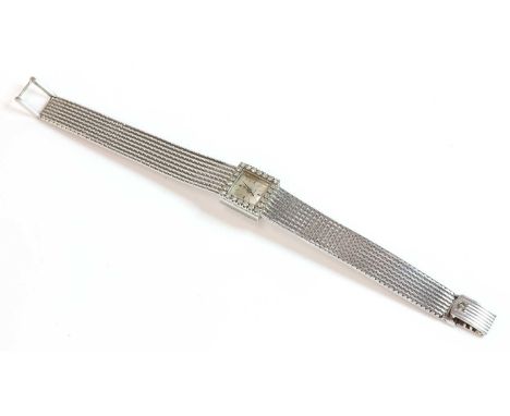 A ladies' 18ct white gold Omega diamond set mechanical bracelet watch, c.1960,the case 14.1mm diameter with a square silvered