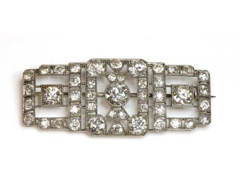 An Art Deco diamond set plaque brooch, c.1925,in a case by Tessiers Ltd. An open rectangular stepped brooch with re-entrant c